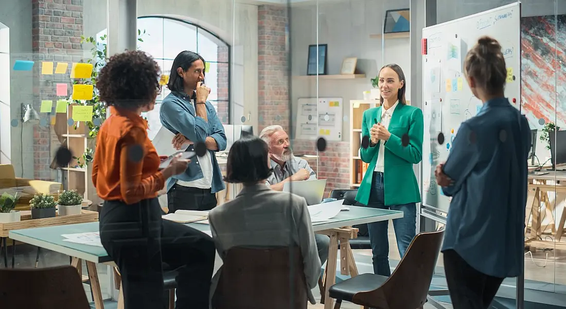 A female manager speaks with her team.