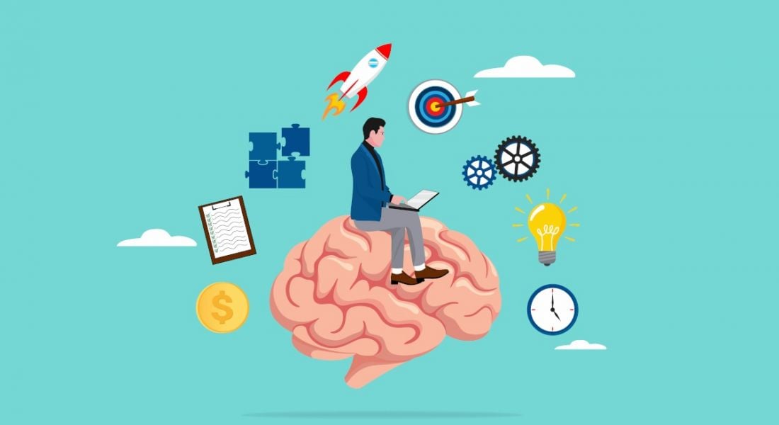 A cartoon image of a man working on a laptop while sitting on a brain. He is surrounded by symbols of learning, such as a jigsaw, a lightbulb and a bullseye.