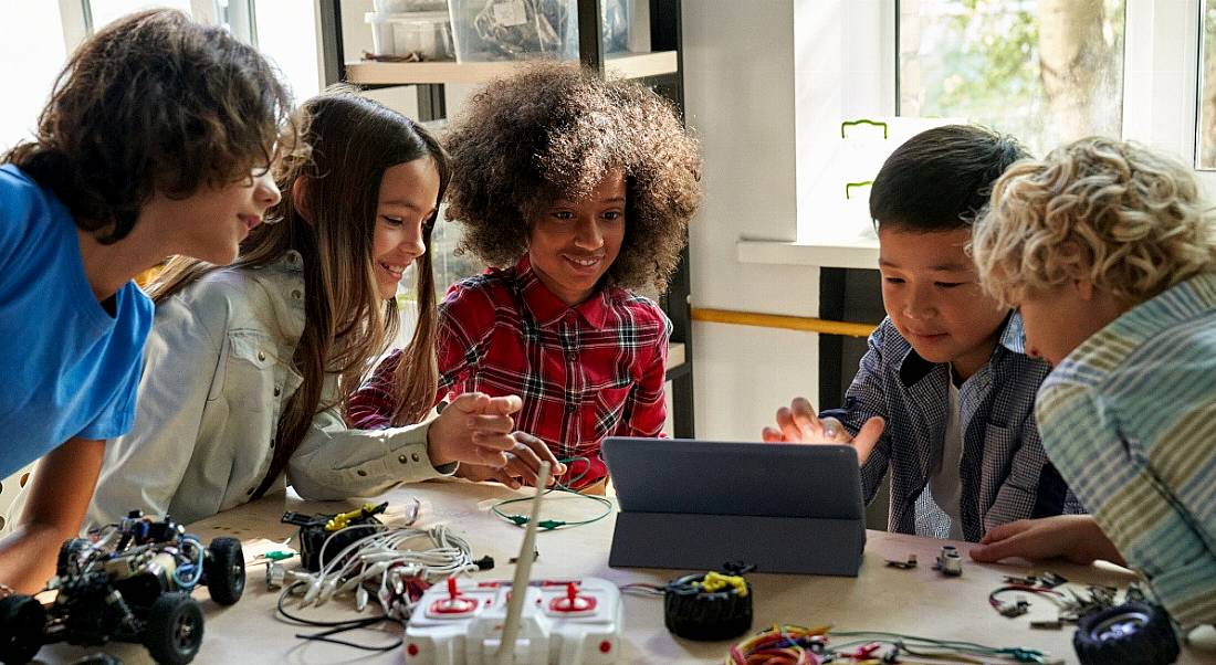 Diverse children collaborate on a STEM project.