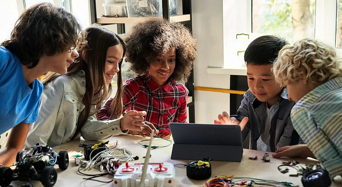 Diverse children collaborate on a STEM project.