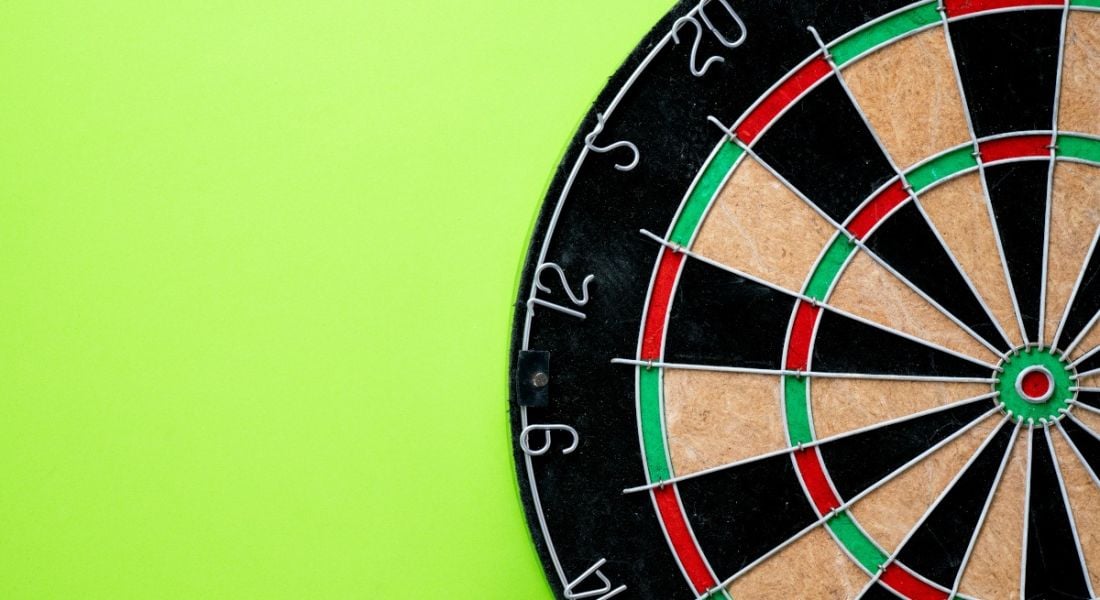 Dart board with the centre target visible on a green background.