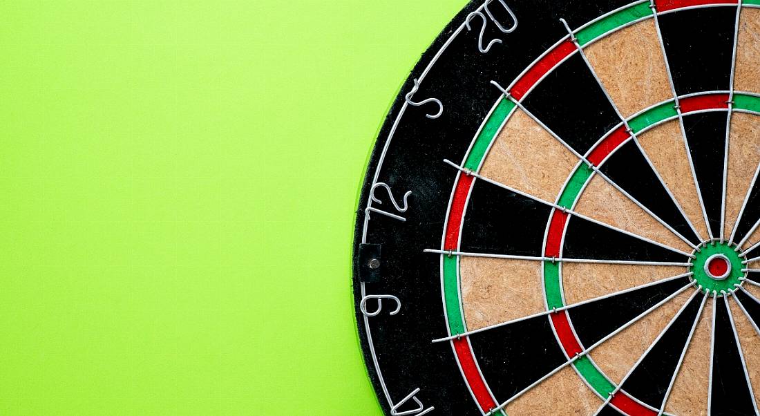 Dart board with the centre target visible on a green background.