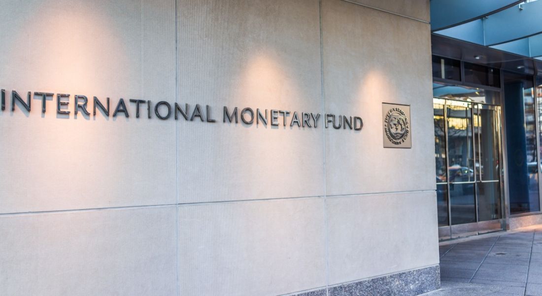 The entrance to a building with the IMF logo on the wall outside it.