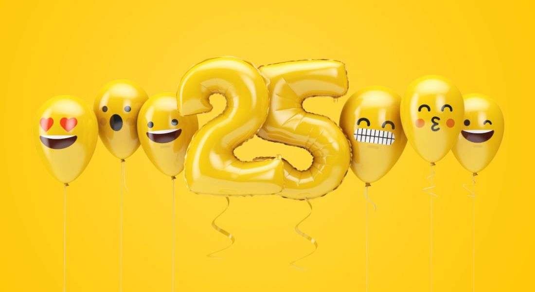Yellow balloons in the shape of the number 25 flanked by emoji balloons on a yellow background.