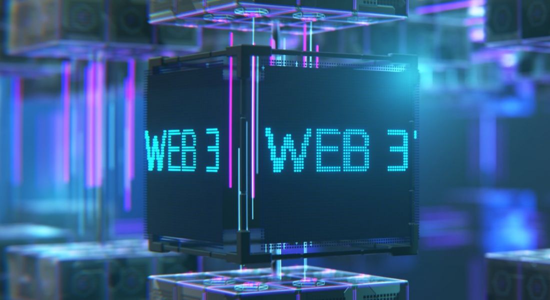 A cube with Web3 written on it in neon blue letters. The background is digitised in blue and purple lights.