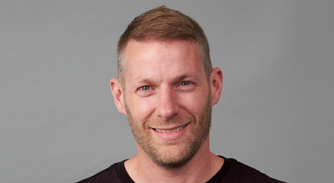 A headshot of Stuart Greenlees of Liberty IT against a grey background.