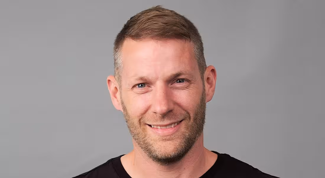 A headshot of Stuart Greenlees of Liberty IT against a grey background.