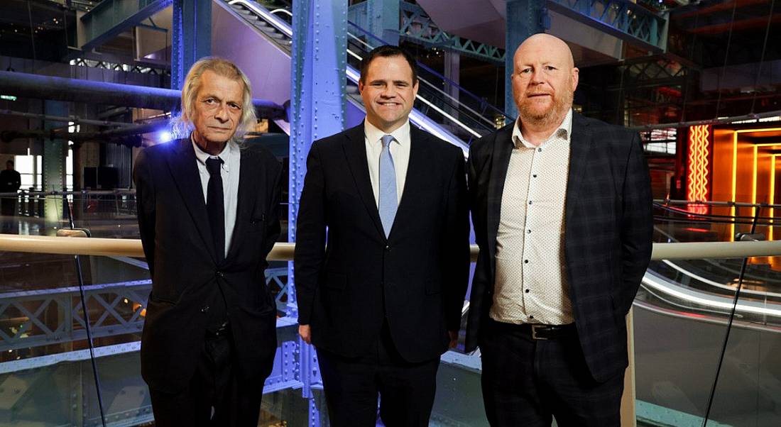 Three men standing in a room prepped for an event between Greenvolt and Enerpower.