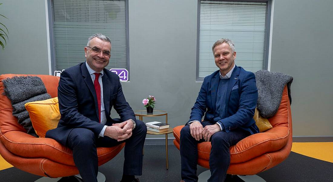 Two men in suits, Minister Dara Calleary, TD, and Buymedia CEO Fergal O'Connor, sit in chairs smiling at the camera.