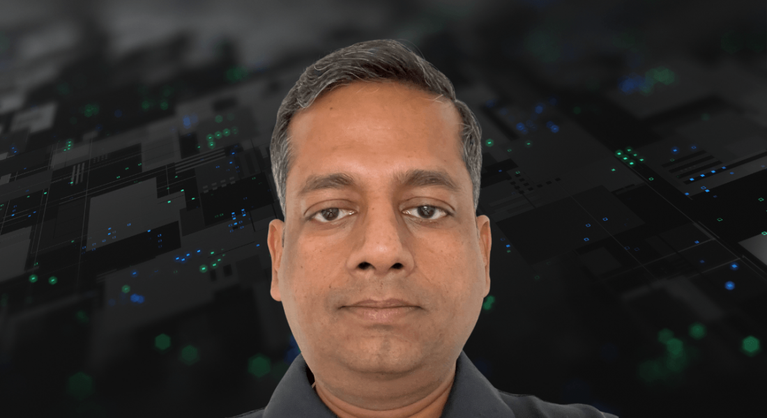 A man wearing a dark shirt with a digital background behind him. He is Anshul Goyal, a senior solutions architect at Deloitte.
