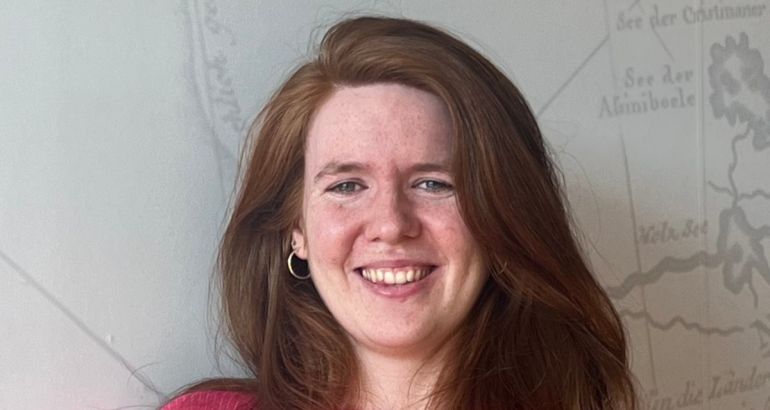 A close-up headshot of a young woman with red hair. She is Rachel Lawton, senior software engineer in Red Hat.