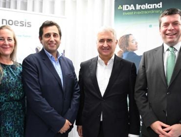 A woman and three men stand in front of signs for Noesis and IDA Ireland.