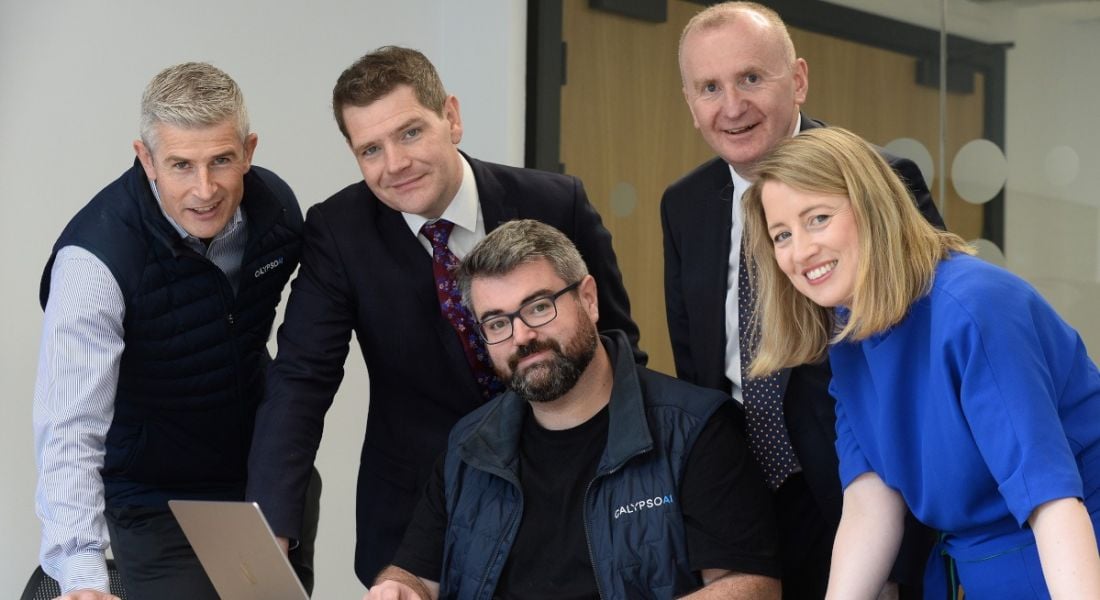 Four men and one woman smile with each other at the opening of the Dublin CalypsoAI office.