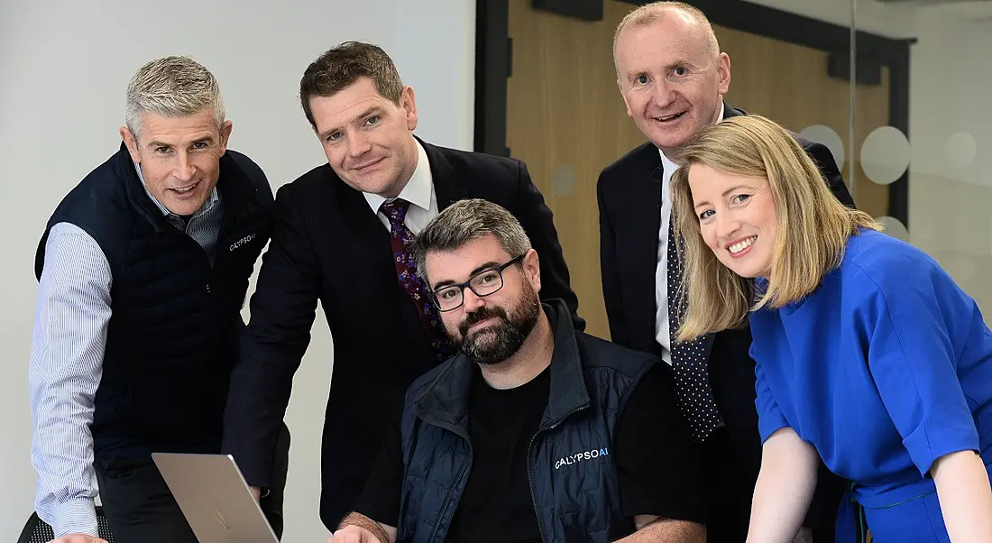 Four men and one woman smile with each other at the opening of the Dublin CalypsoAI office.