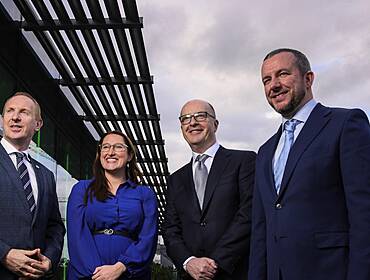 From left: Michael Lohan, CEO, IDA Ireland; Minister of State Emer Higgins, TD; Tom Clarke, West; and Simon Frainey, West, all posing outside a building with a grey sky in the background.