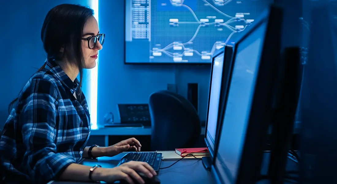 A woman works on her laptop as a data scientist.