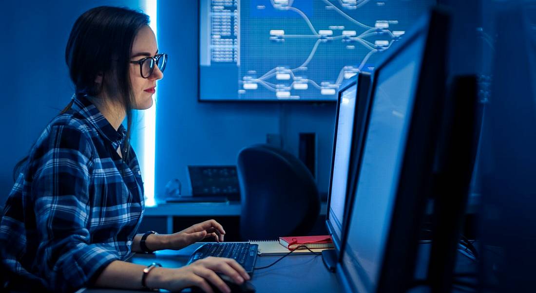 A woman works on her laptop as a data scientist.