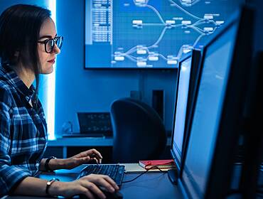 A woman works on her laptop as a data scientist.