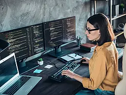 A penguin figure sitting on a computer keyboard with a gold crown beside it. The penguin in this case represents Linux.