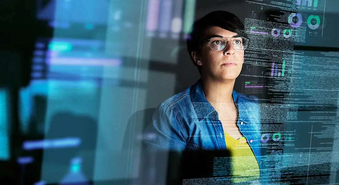 A female software engineer works at her laptop coding.