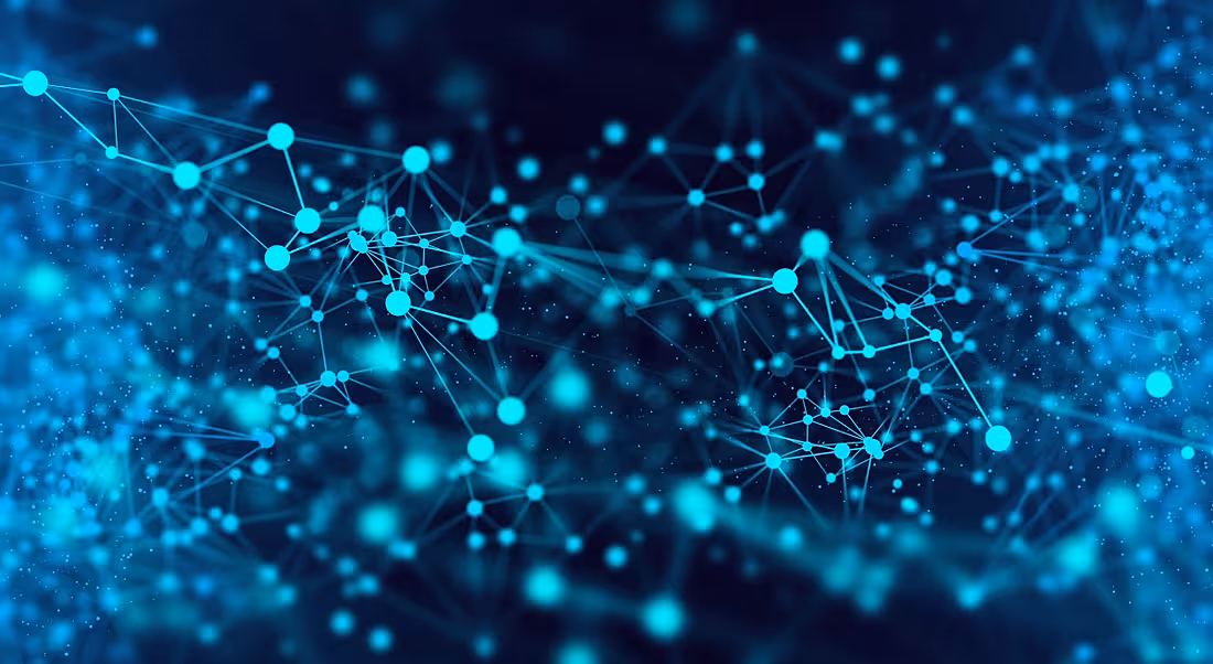 A light and blue rendering of AI as seen in wired connections.