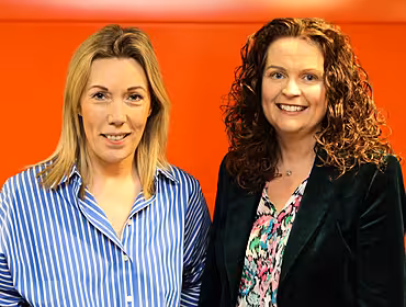 Fidelity Investments Karen Conway and Eimear Coffey, stand against an orange background.
