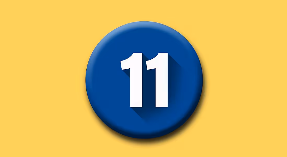 A white number eleven on a round blue button on top of a yellow background.