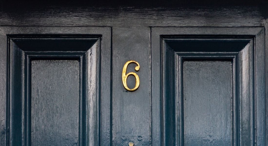 Number six on a dark blue front door.