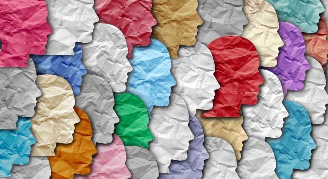 Illustration of different coloured paper heads laid out across each other.