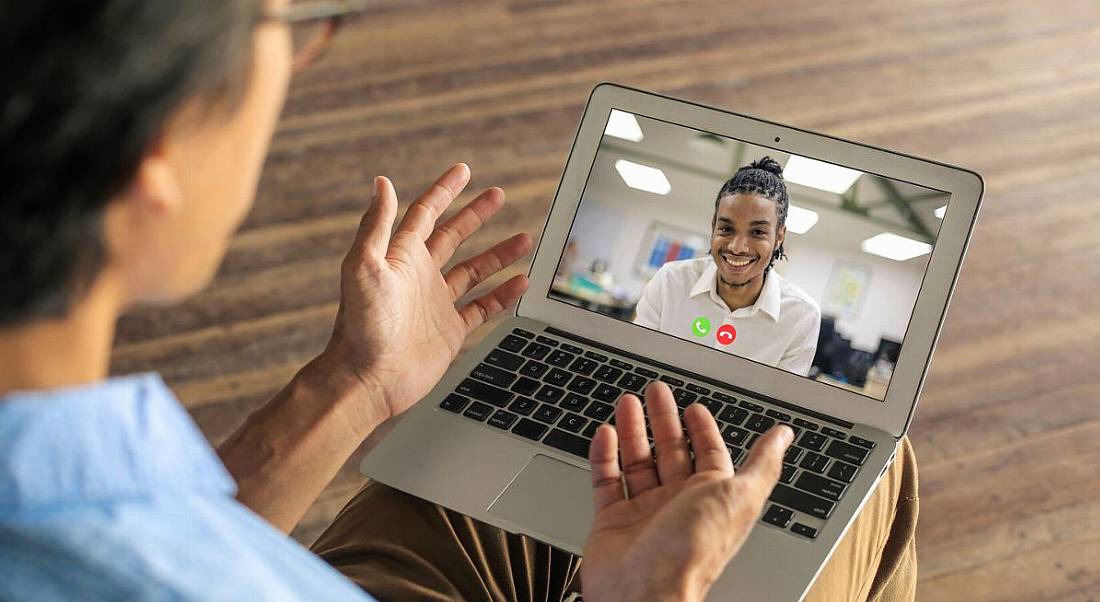 Two people are talking on a video call as part of a remote hiring process.