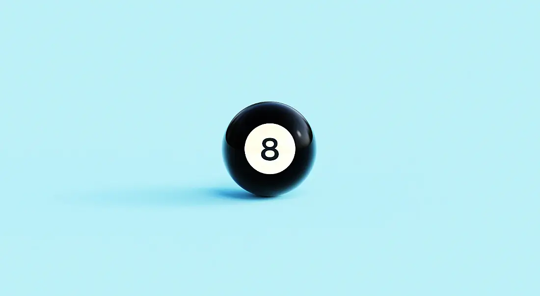 Black magic eight ball against a pale blue background.