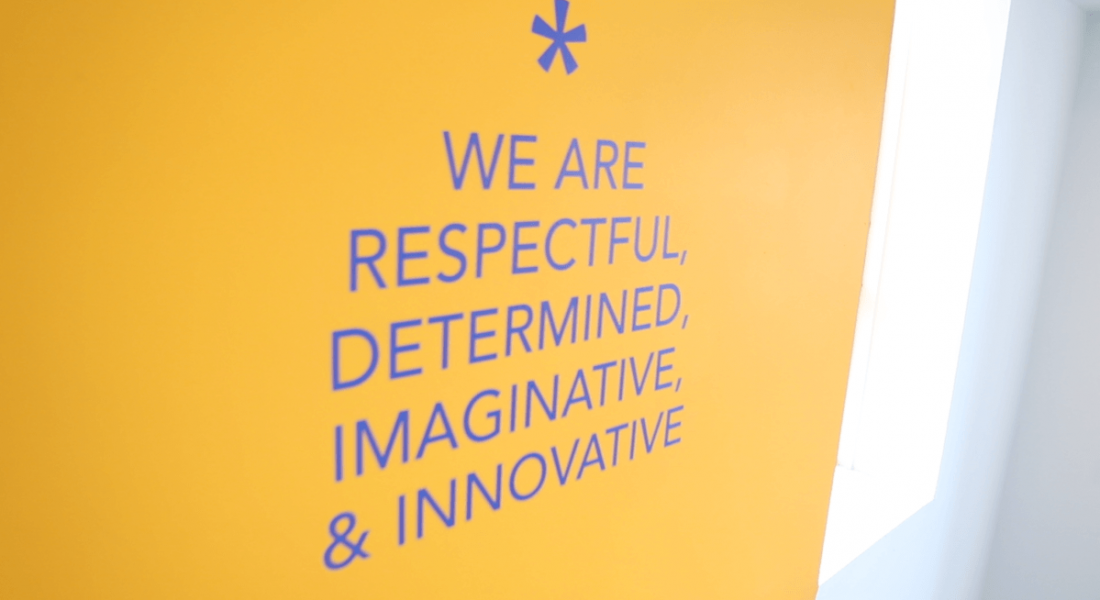 The core values at Workhuman are painted in blue on a yellow wall at the company’s Dublin office.