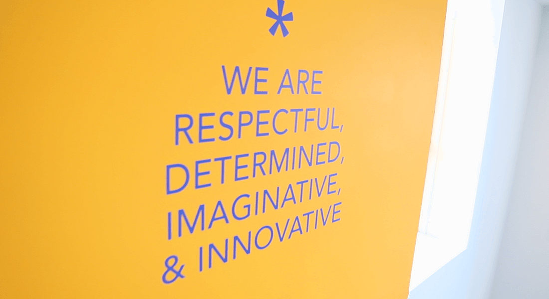 The core values at Workhuman are painted in blue on a yellow wall at the company’s Dublin office.