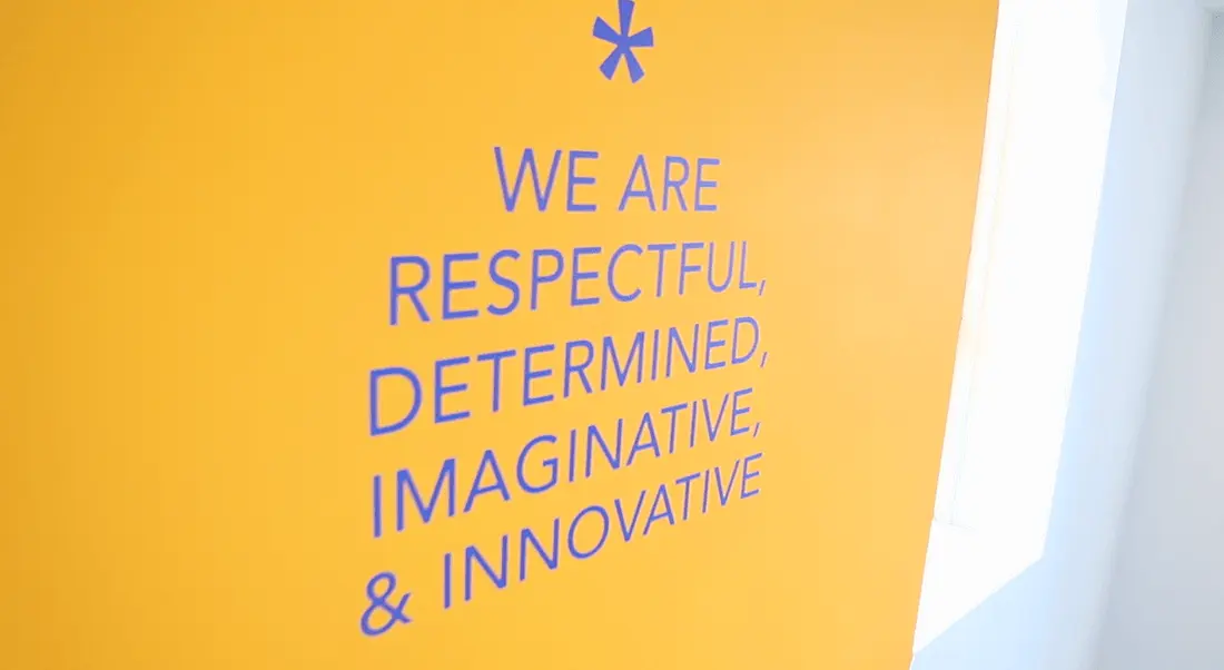 The core values at Workhuman are painted in blue on a yellow wall at the company’s Dublin office.