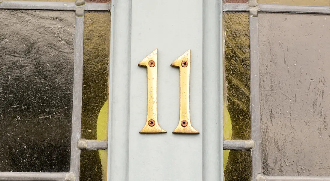 Number 11 on a grey front door.