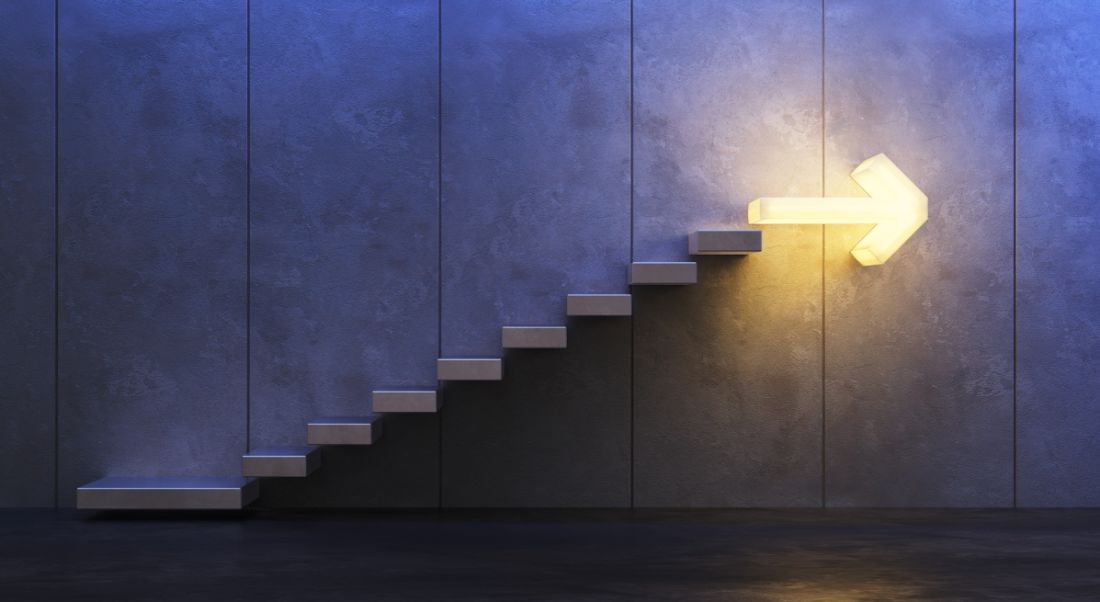 Stairs going upwards with an arrow-shaped light at the top.