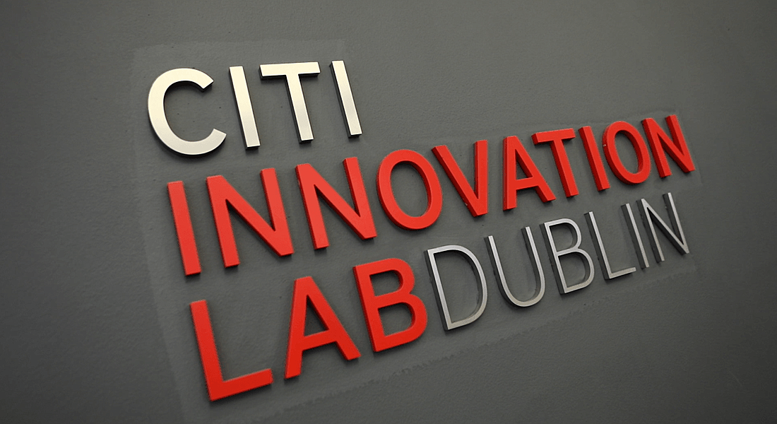 A sign for the Citi Innovation Lab Dublin is in white and red font on a grey wall.