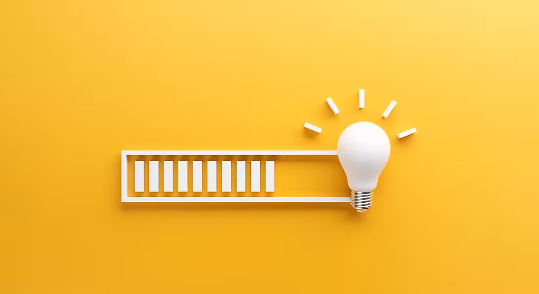 A white loading bar leading to a light bulb against a yellow background.