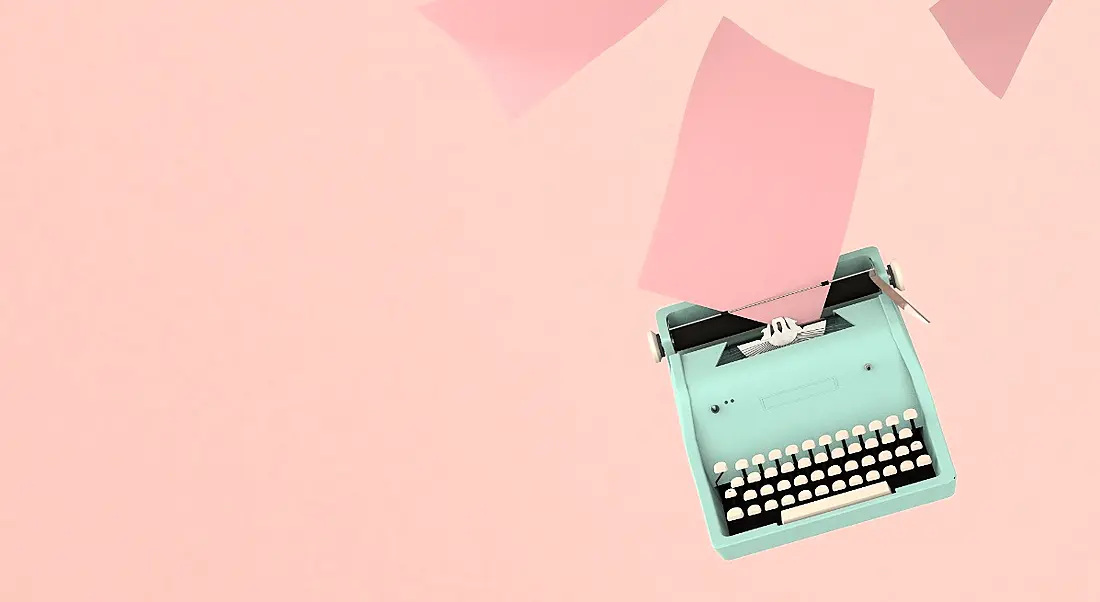 Retro blue typewriter with paper sheets on pink background, symbolising CV updates.