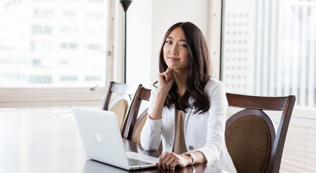 Jessica Mah of InDinero is sitting in a brightly lit office smiling into the camera.