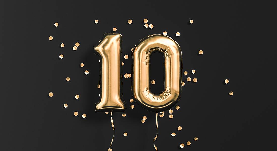 Number 10 gold foil balloons on a black background.