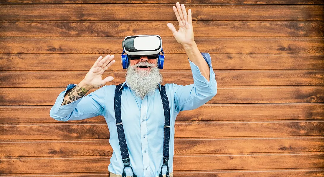 An employee is having fun while wearing a VR headset.