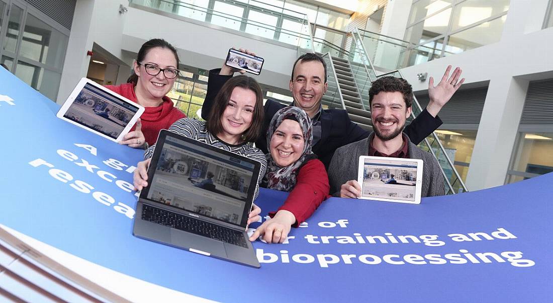 A group of colleagues are standing together and smiling into the camera at the launch of the NOA at NIBRT.