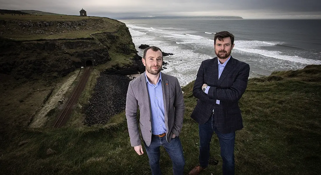 Lee Stuart and Jim Campbell from Covernet are standing on cliffs on the Irish north-west coast and looking into the camera.