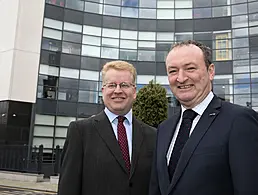 Lee Stuart and Jim Campbell from Covernet are standing on cliffs on the Irish north-west coast and looking into the camera.