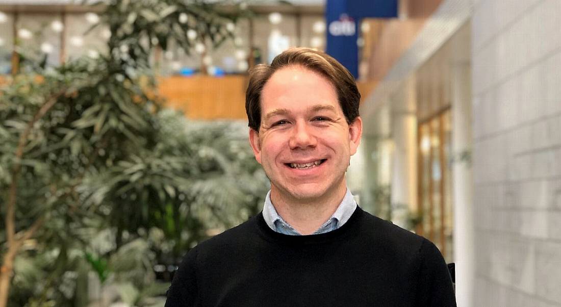 Matthew Beckingham, data scientist at Citi, is smiling into the camera at the company's offices in Dublin.