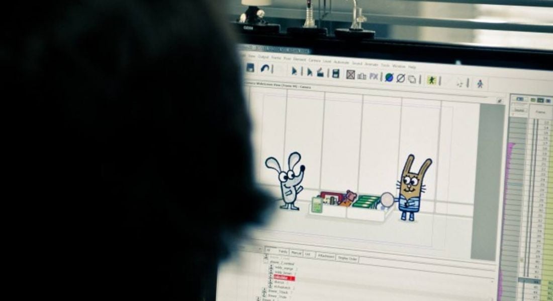 An employee at Kavaleer Productions working on an animation on a computer.