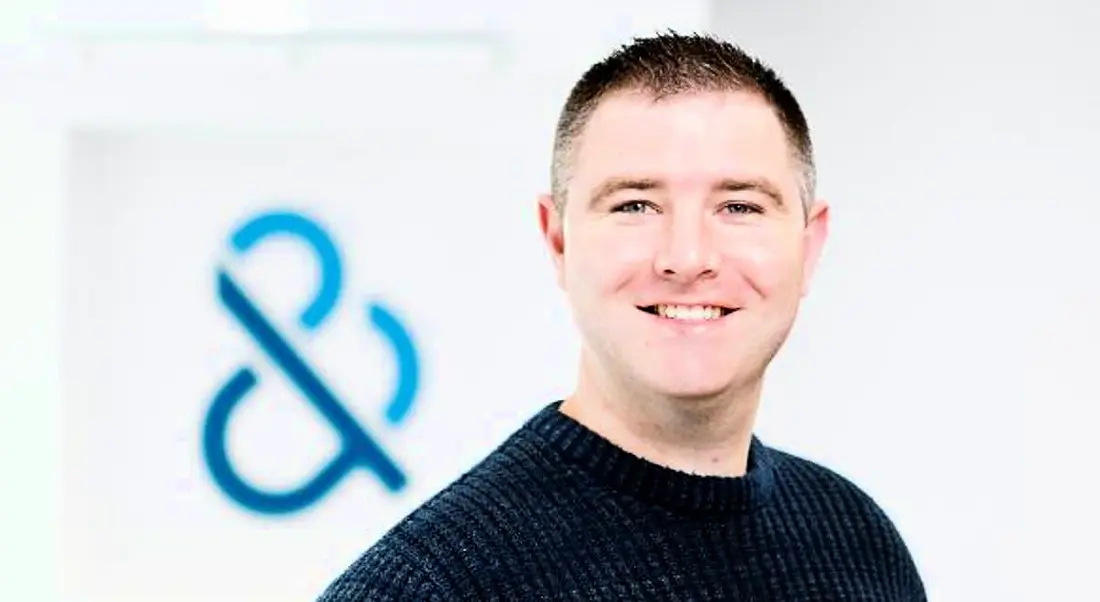 Dave Hill, who leads recruitment for graduates, is wearing a navy jumper and smiling into the camera at the Dun & Bradstreet office.