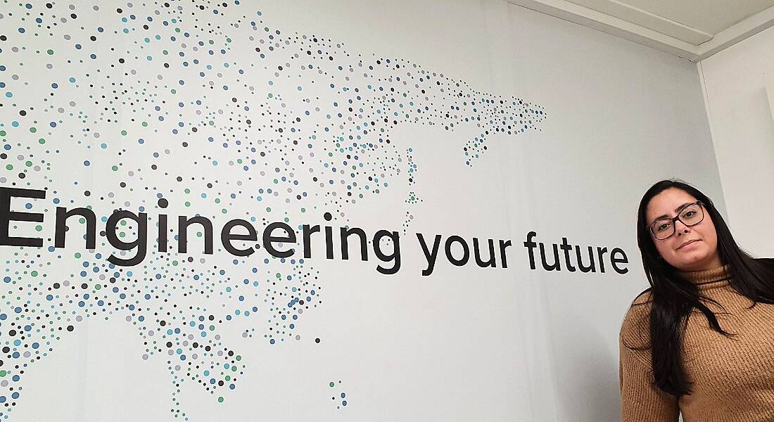 Luiza Brack is standing in front of a wall that says 'Engineering your Future'.