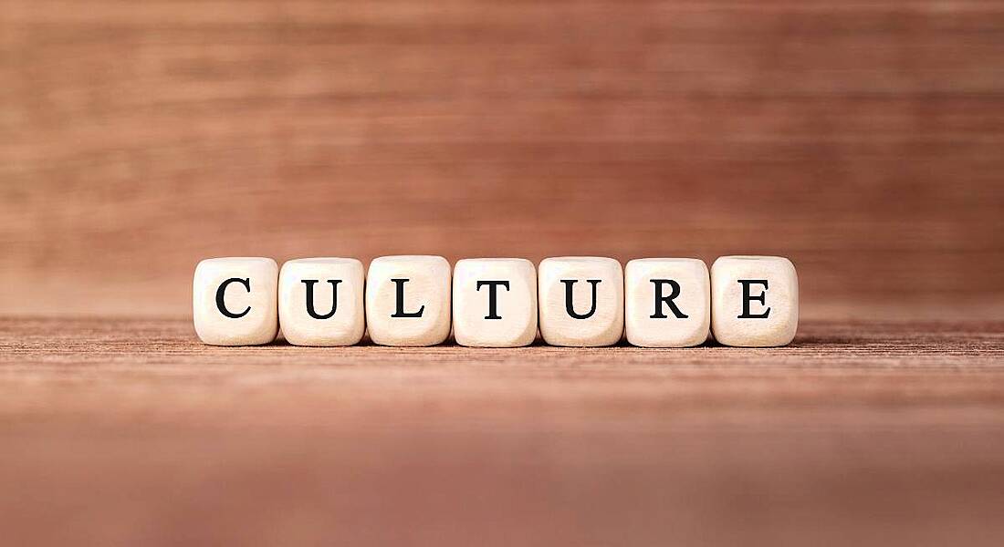 The word 'culture' spelled out with wooden building blocks.